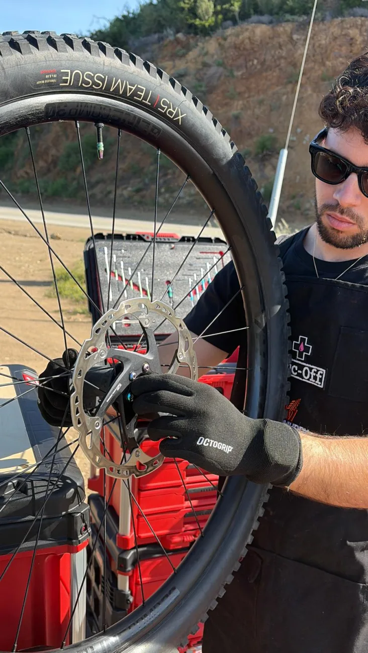 Inspecting a disc brake rotor and wheel in gloves